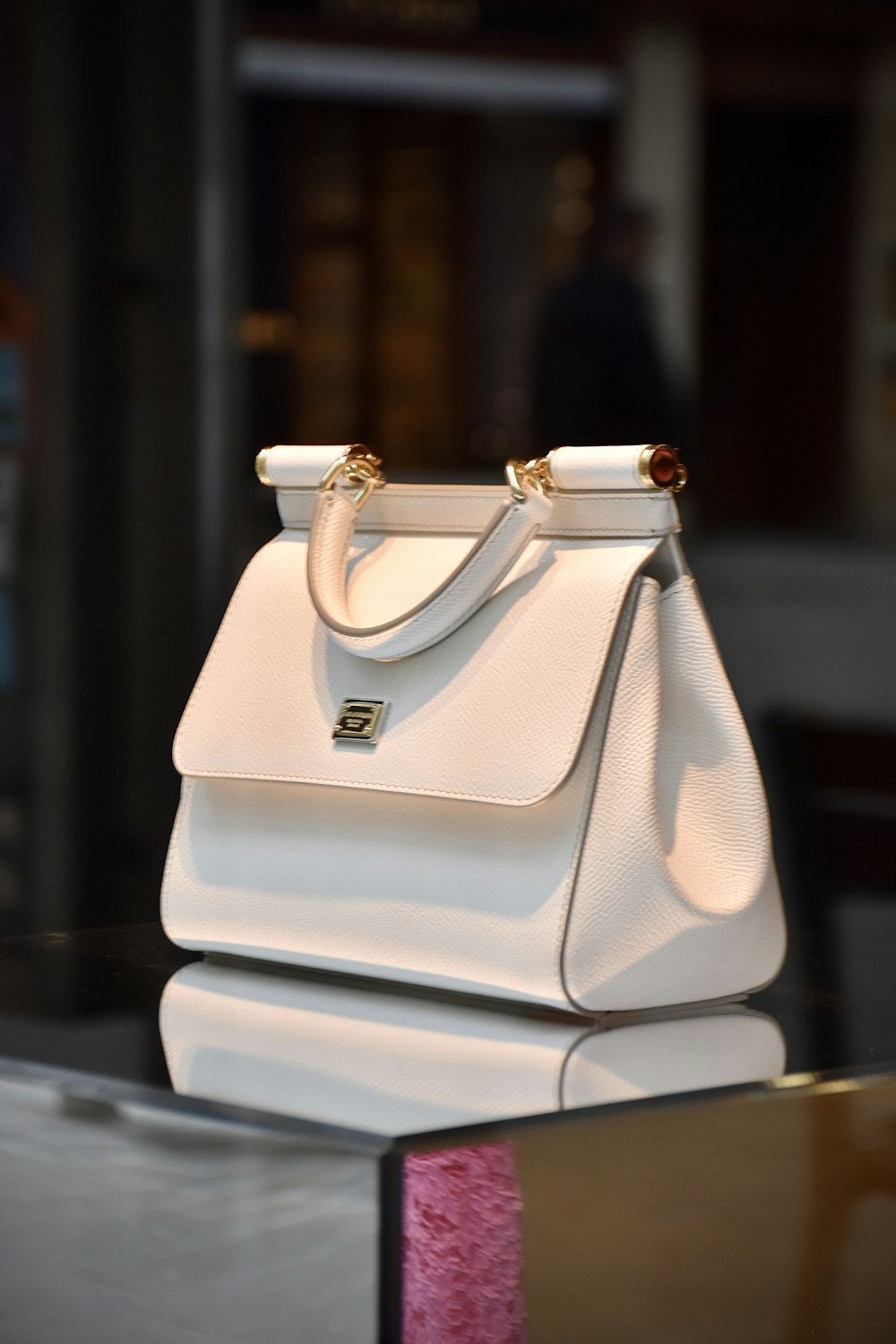 a white purse sitting on top of a table