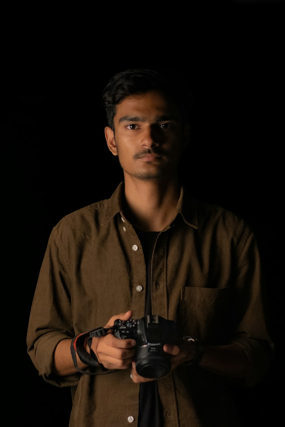 a man holding a camera in his hands