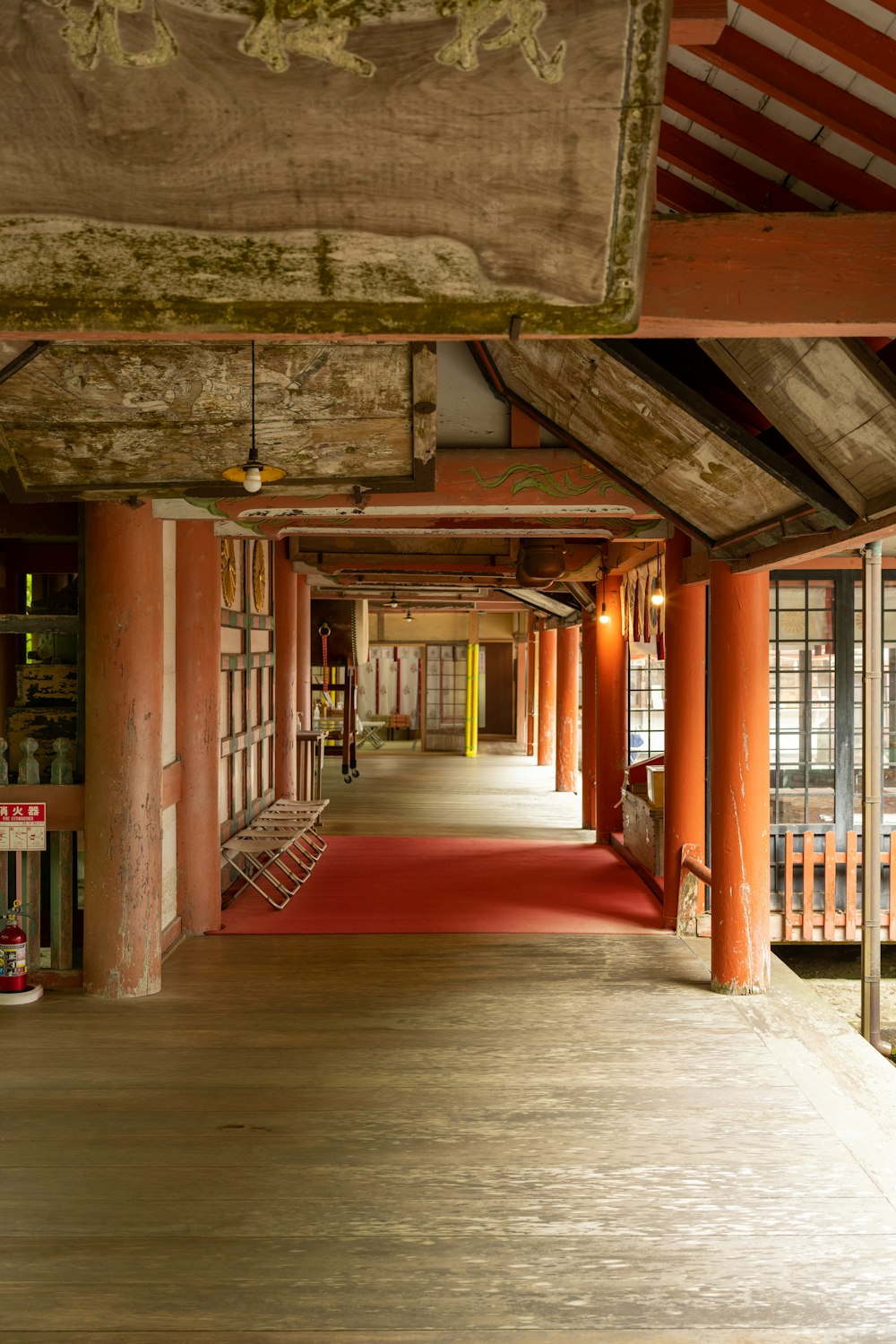 a long hallway in a building with red carpet