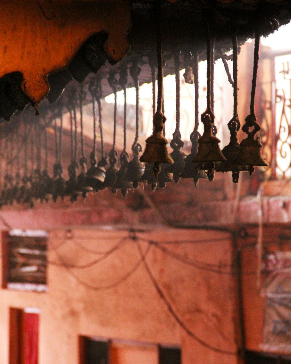 a bunch of bells hanging from a ceiling