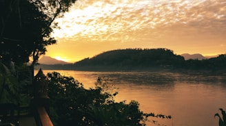 Sunset view over the river beside the luxury retreat, with hills in the background.