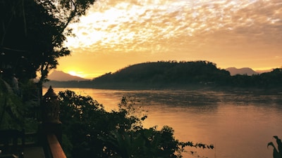 Sunset view over the river beside the luxury retreat, with hills in the background.