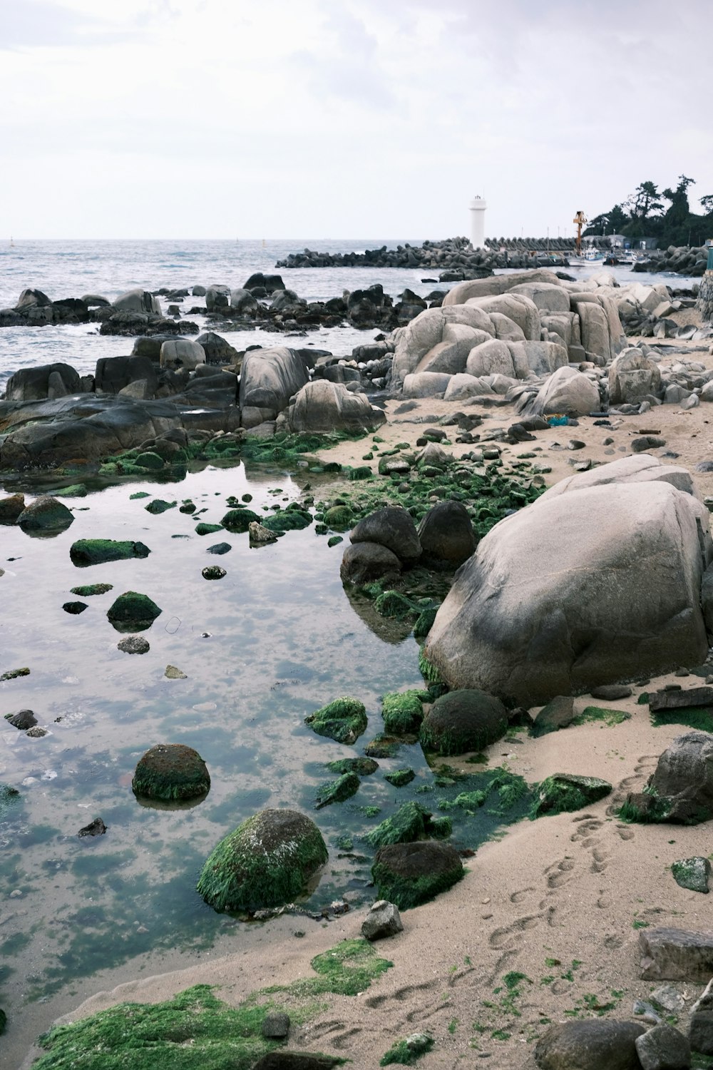 a large rock sitting on top of a sandy beach