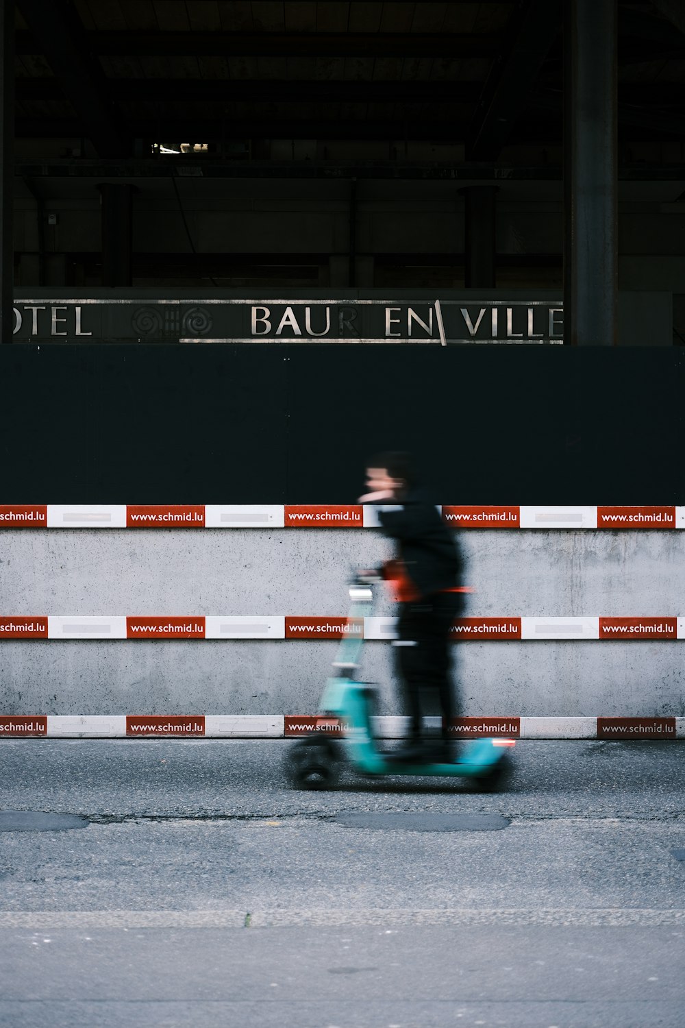 a person riding a scooter on a city street