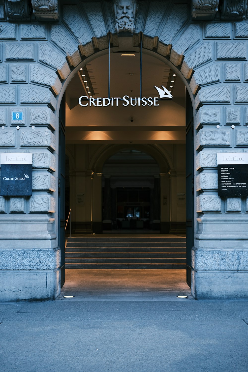 the entrance to a building with a clock on it