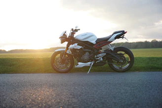 A sleek black motorcycle gleaming under the sunset on an open road