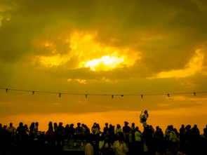 A dramatic sunset backdrop behind a group of friends from a hit show.