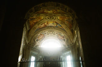 Detail of a restored ceiling with original frescoes and subtle lighting.