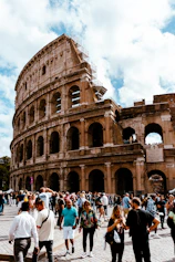 a crowd of people standing around an old building