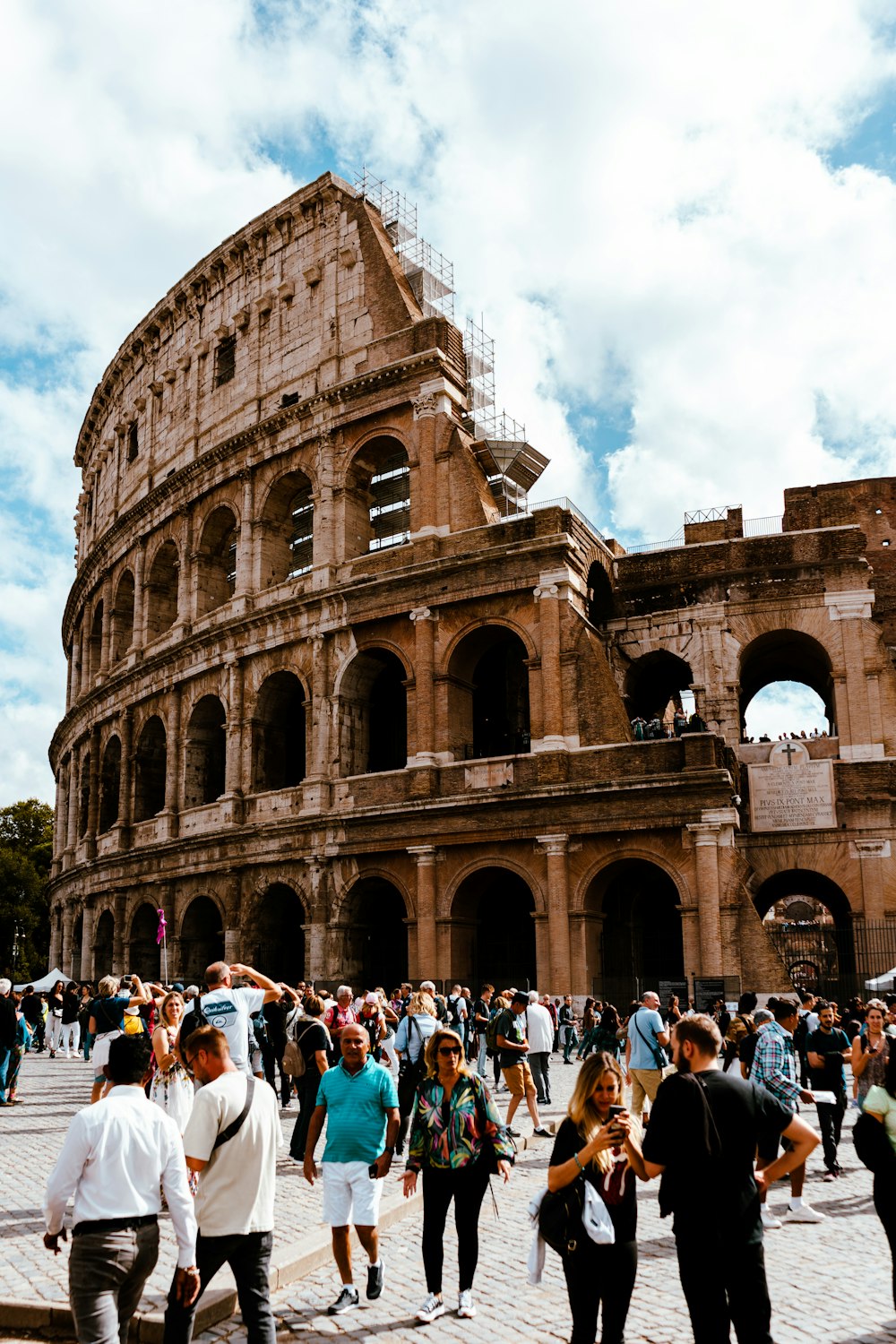 a crowd of people standing around an old building