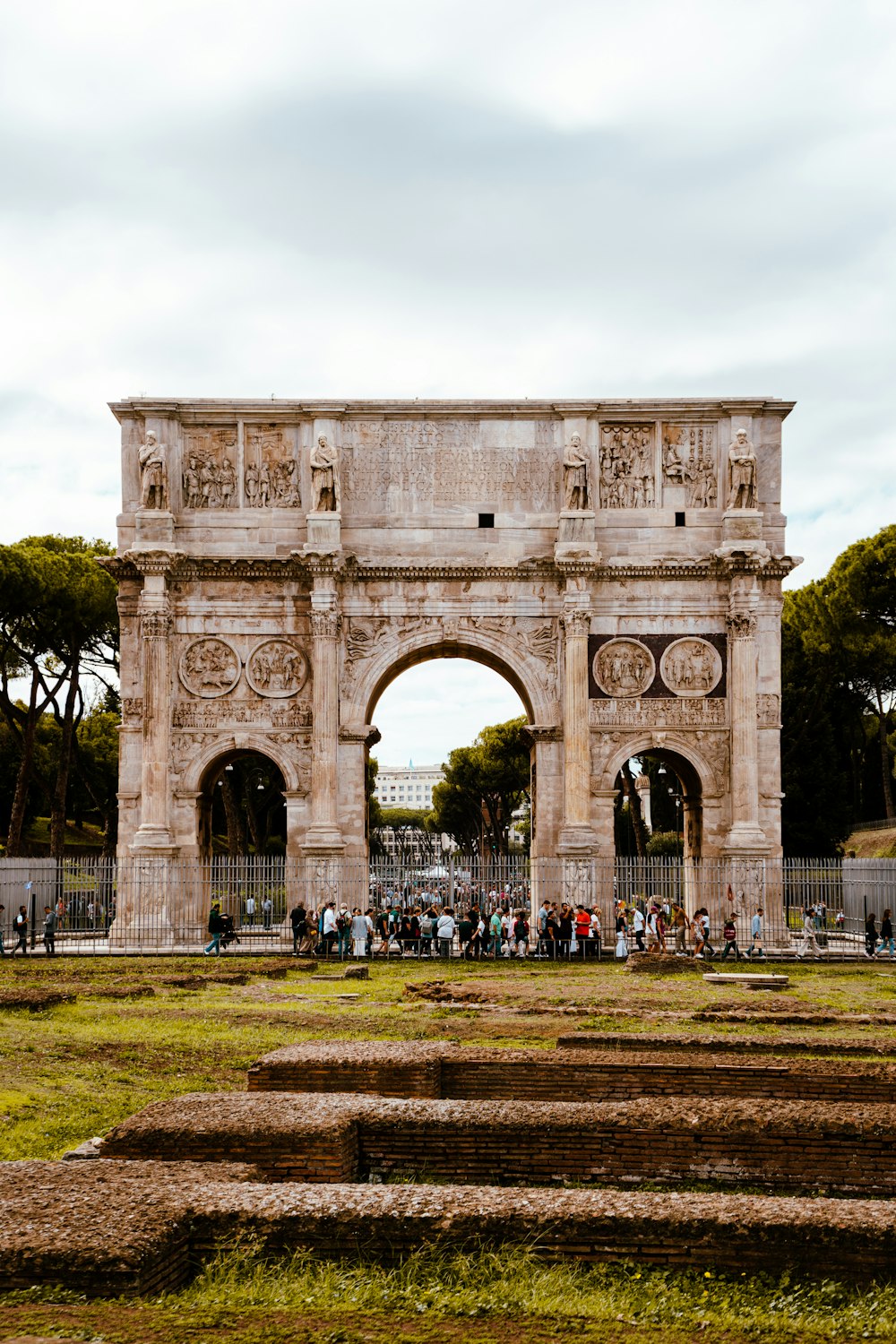 a group of people standing in front of an arch of triumph