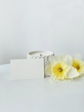 a candle and some flowers on a table