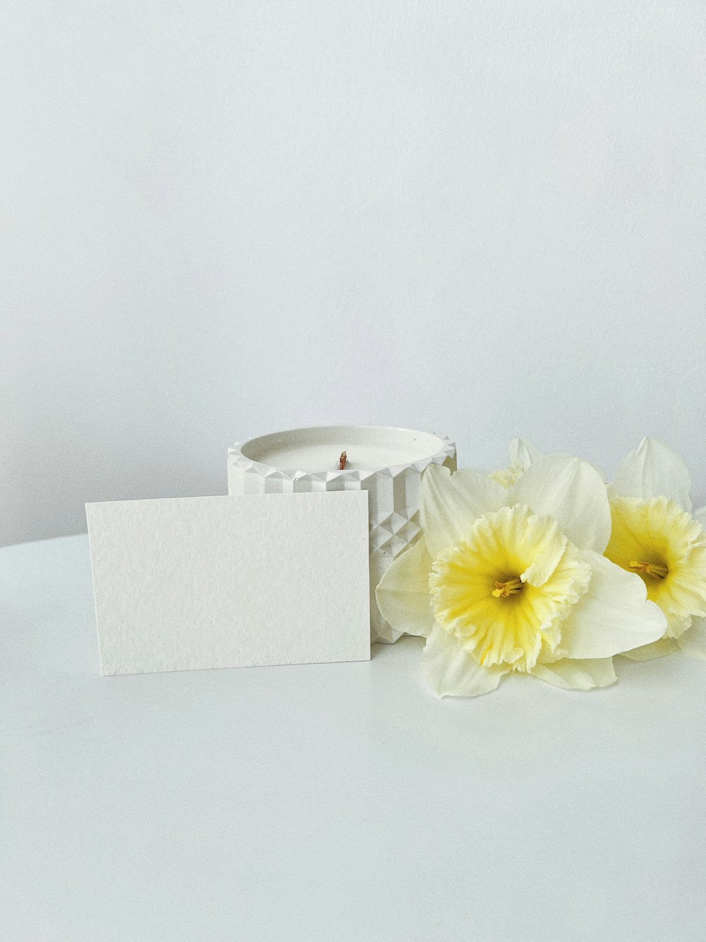 a candle and some flowers on a table