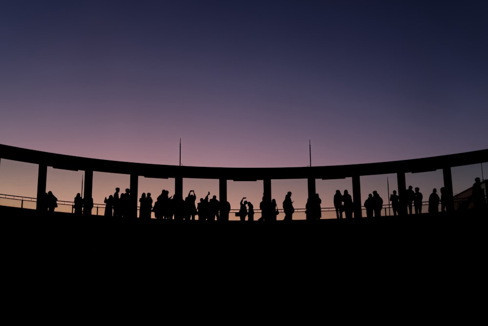 a group of people standing on top of a bridge