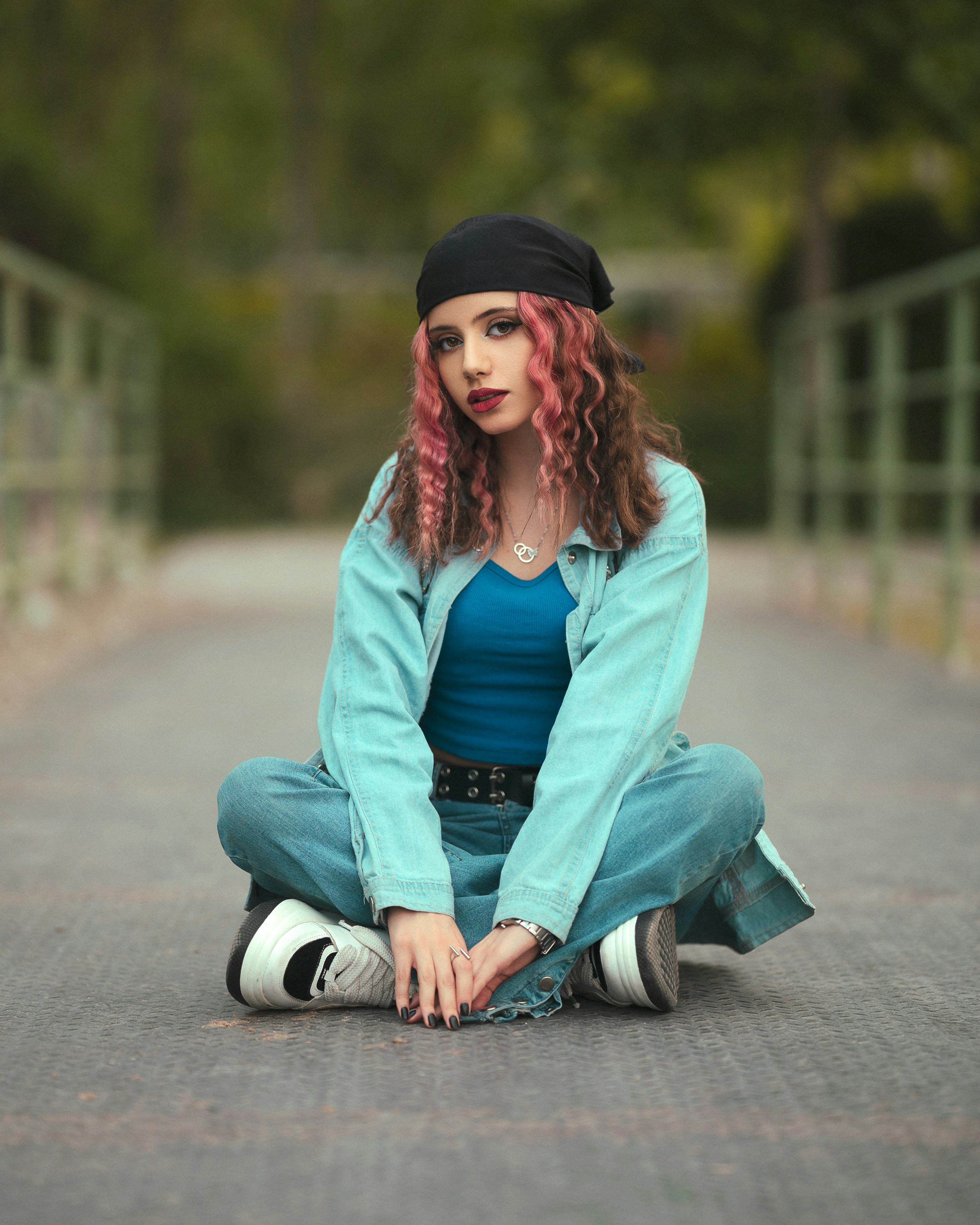 A woman with red hair sitting on the ground