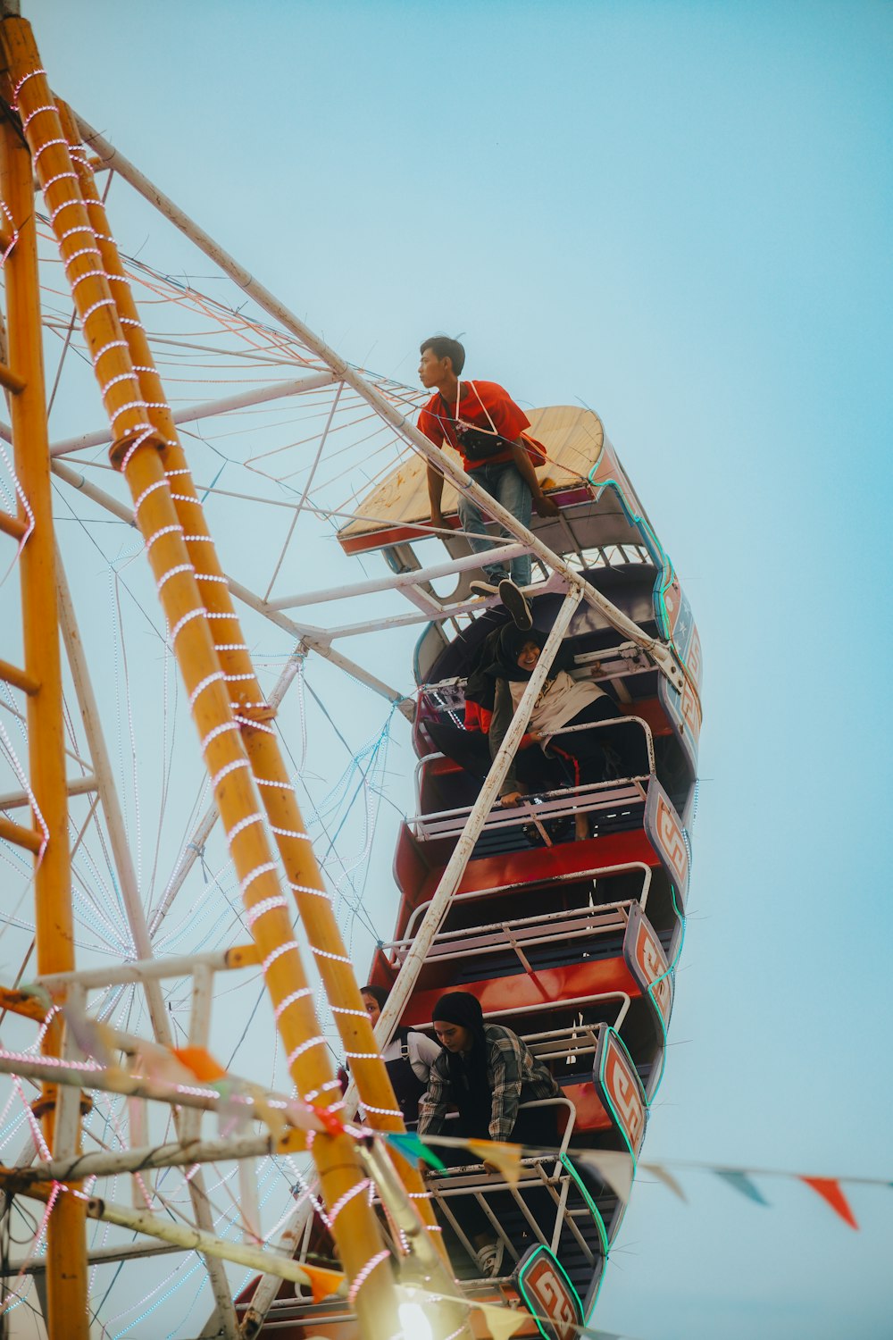 a man standing on top of a ferris wheel
