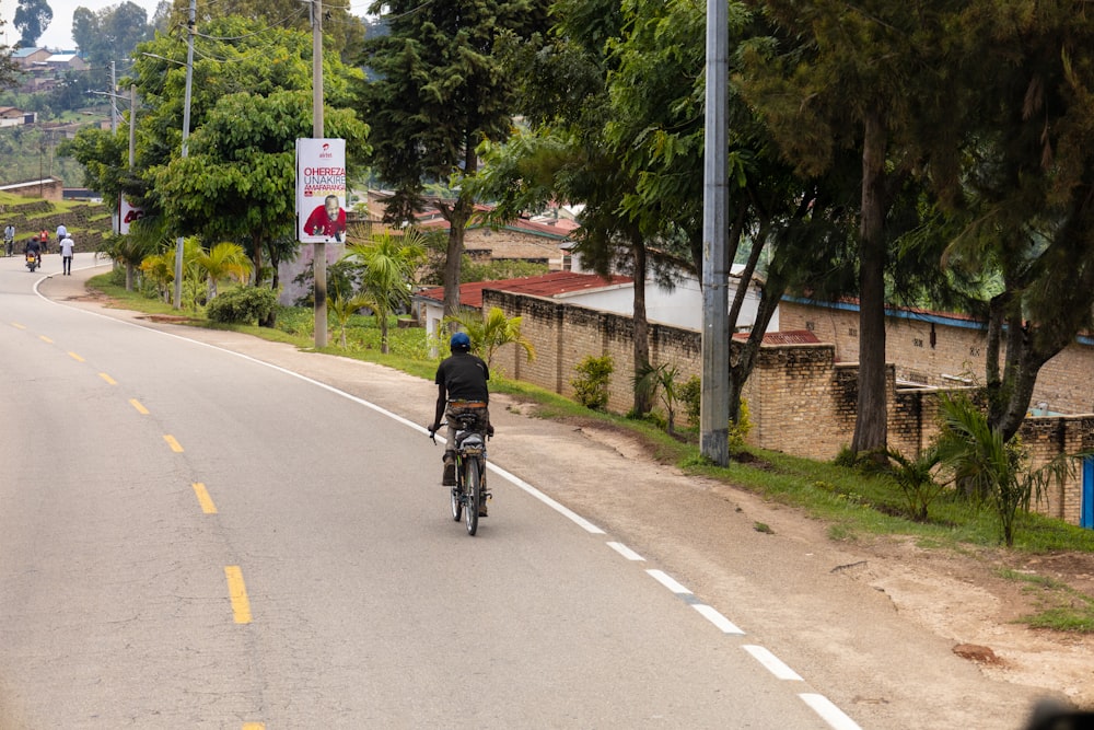 a person riding a bike down a street