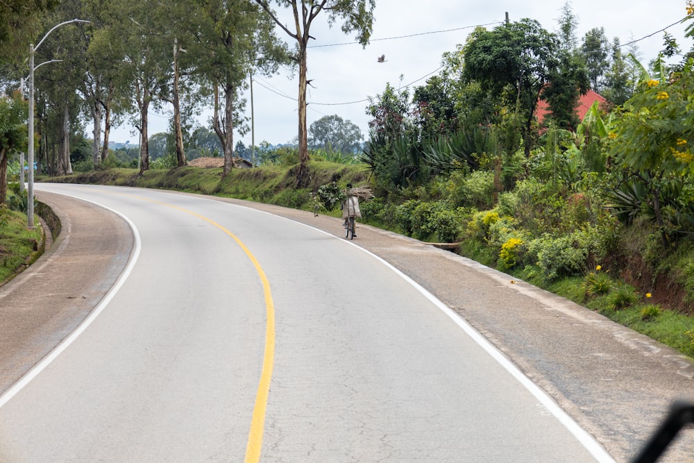 a man riding a motorcycle down a curvy road