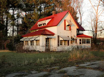 Rustic fixer-upper house with a red roof