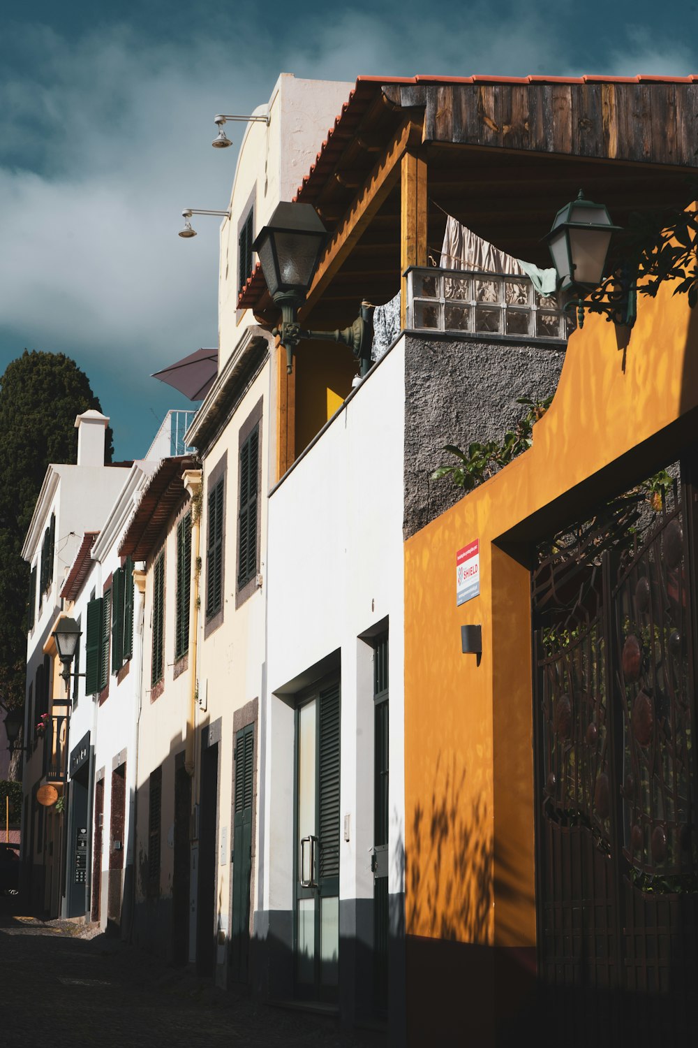 a row of white and yellow buildings on a street