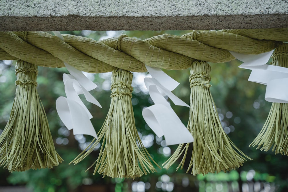 a group of tassels hanging from a beam