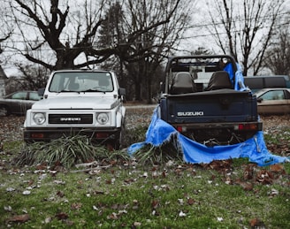 a couple of trucks parked next to each other on a field