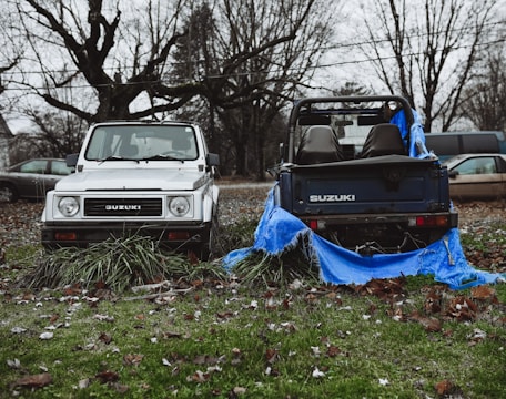 a couple of trucks parked next to each other on a field