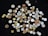 A scattered collection of coins of various sizes, shapes, and colors displayed against a black background. The coins include copper, silver, and gold hues, with some ornate designs and diverse inscriptions visible.