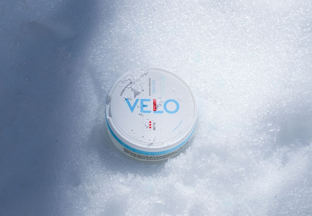 a white container sitting on top of a pile of snow