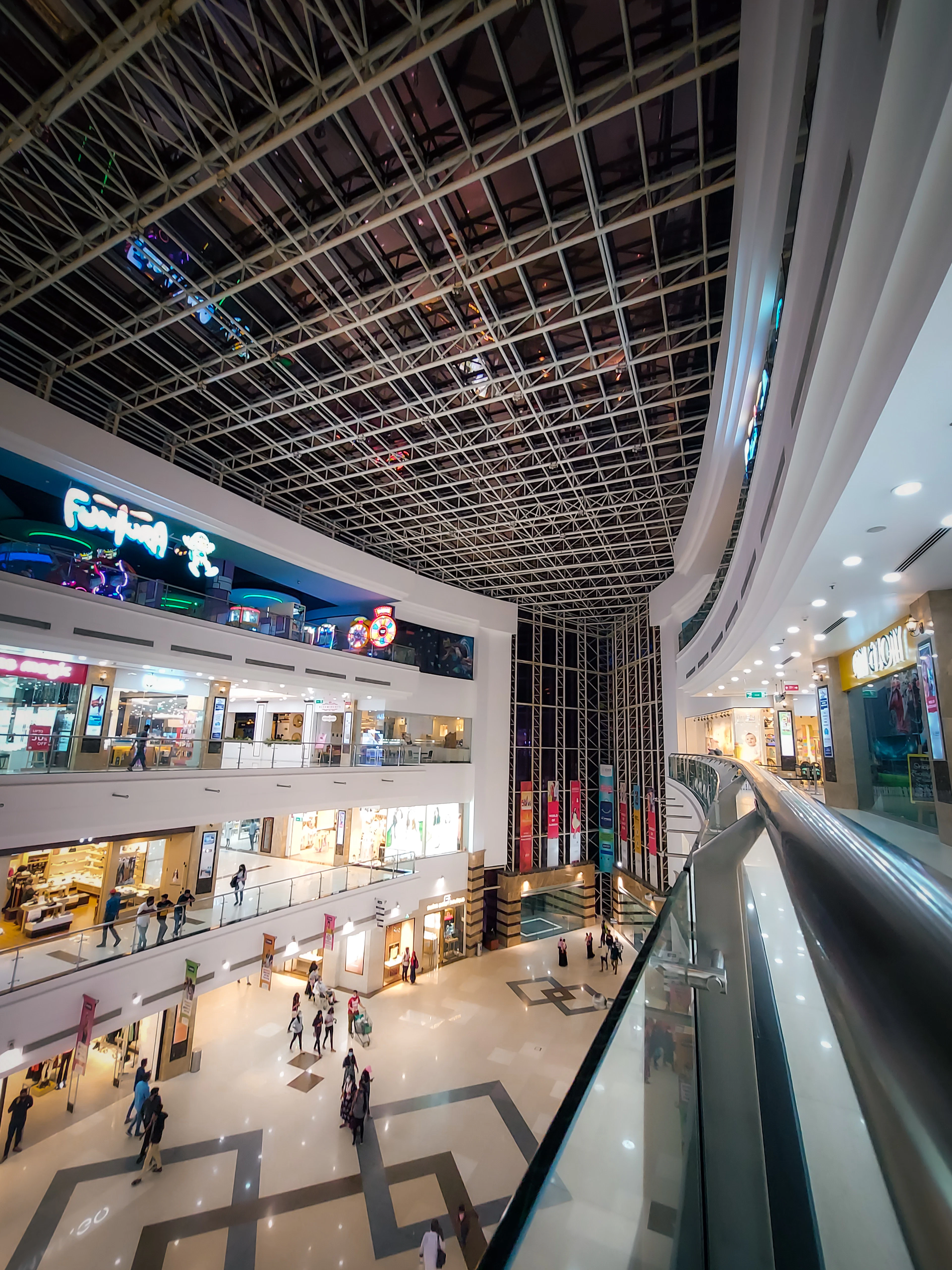 Inside a large shopping mall with shops on several levels