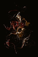 a black background with red and yellow liquid