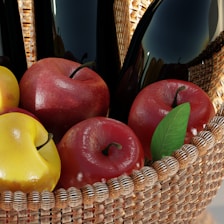 A vibrant basket filled with shiny red and green apples on a rustic wooden table.
