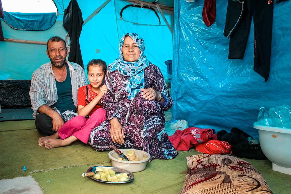 a man and a woman sitting next to a child