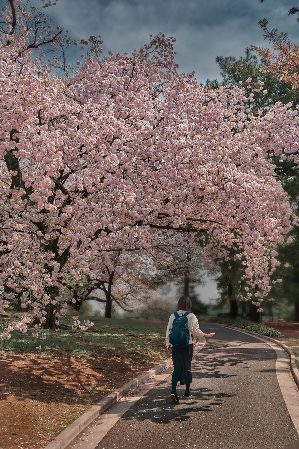 a person with a backpack walking down a street