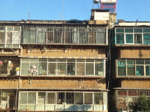 Wide shot of a residential building with stainless steel safety nets on balconies