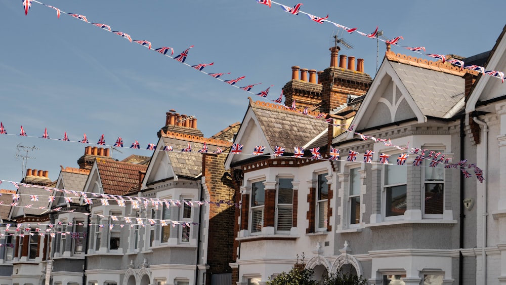 a row of houses with flags flying in the wind