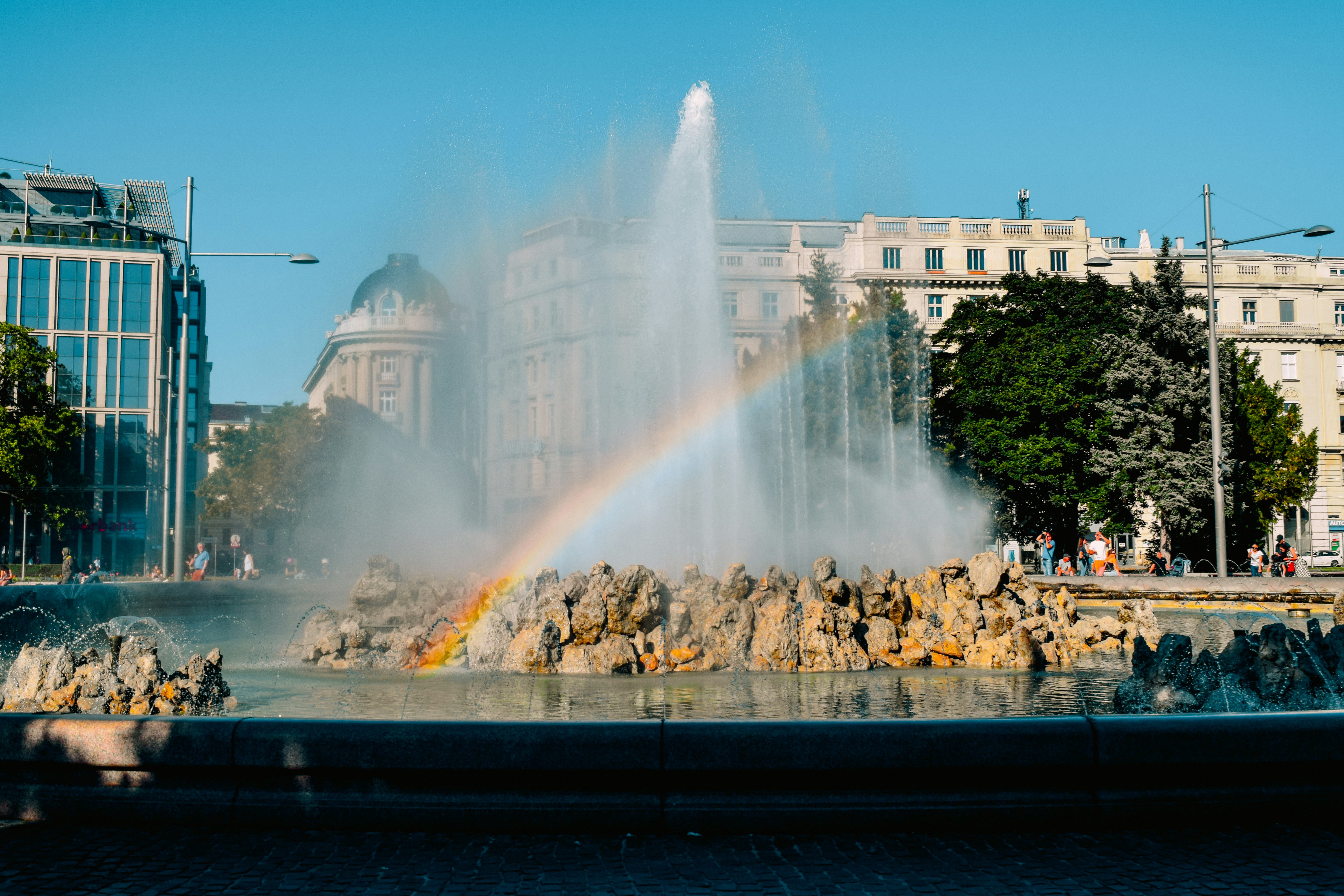 a fountain with a rainbow in the middle of it