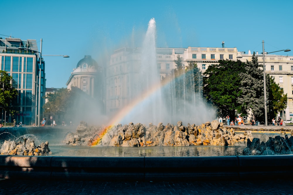 a fountain with a rainbow in the middle of it