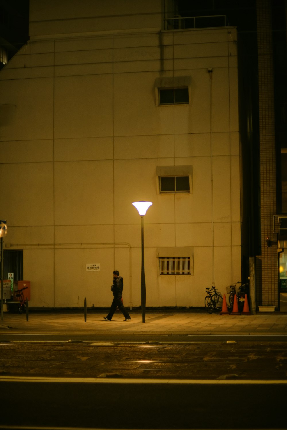 a person walking down a street at night