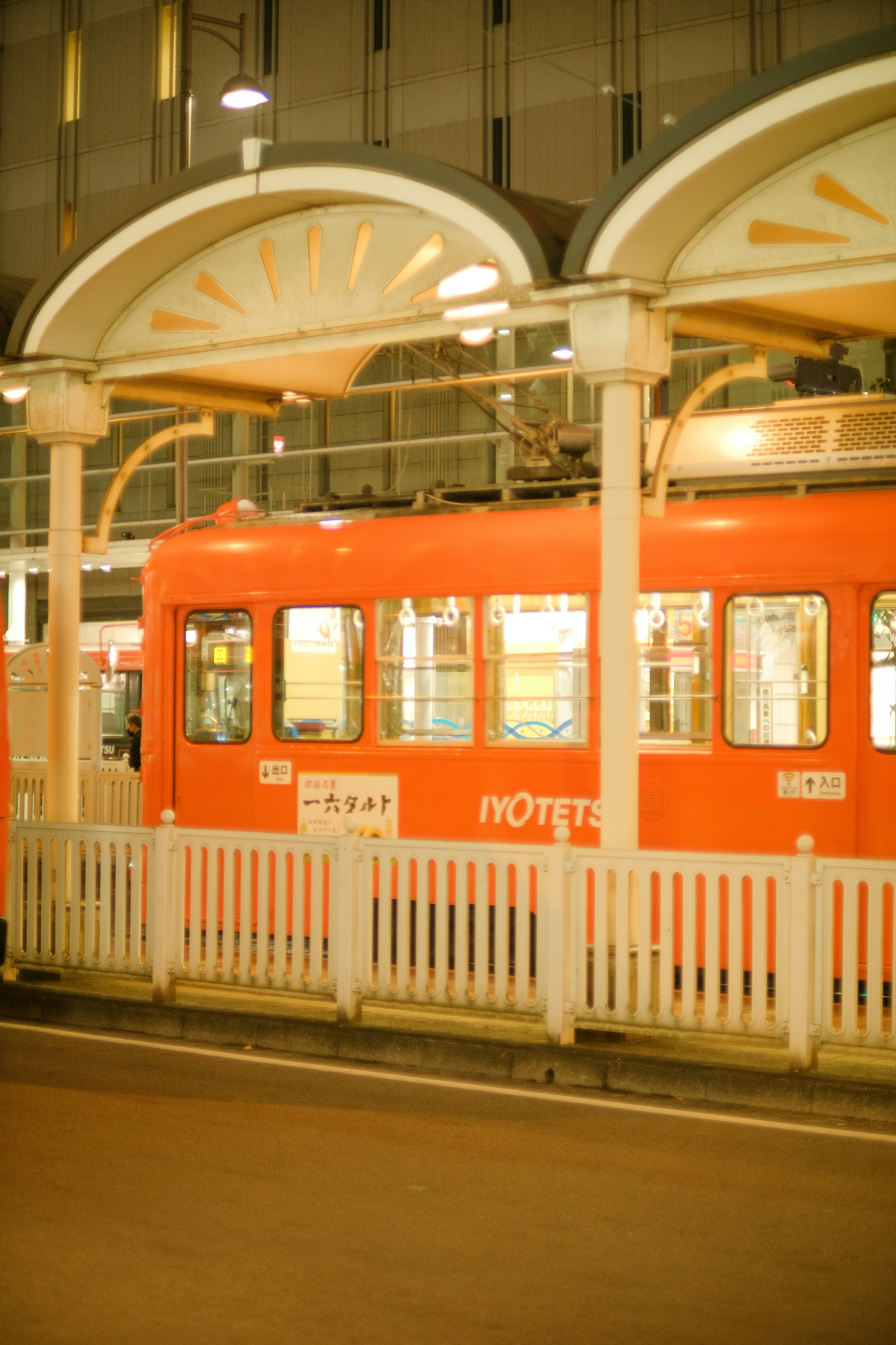 an orange train parked at a train station