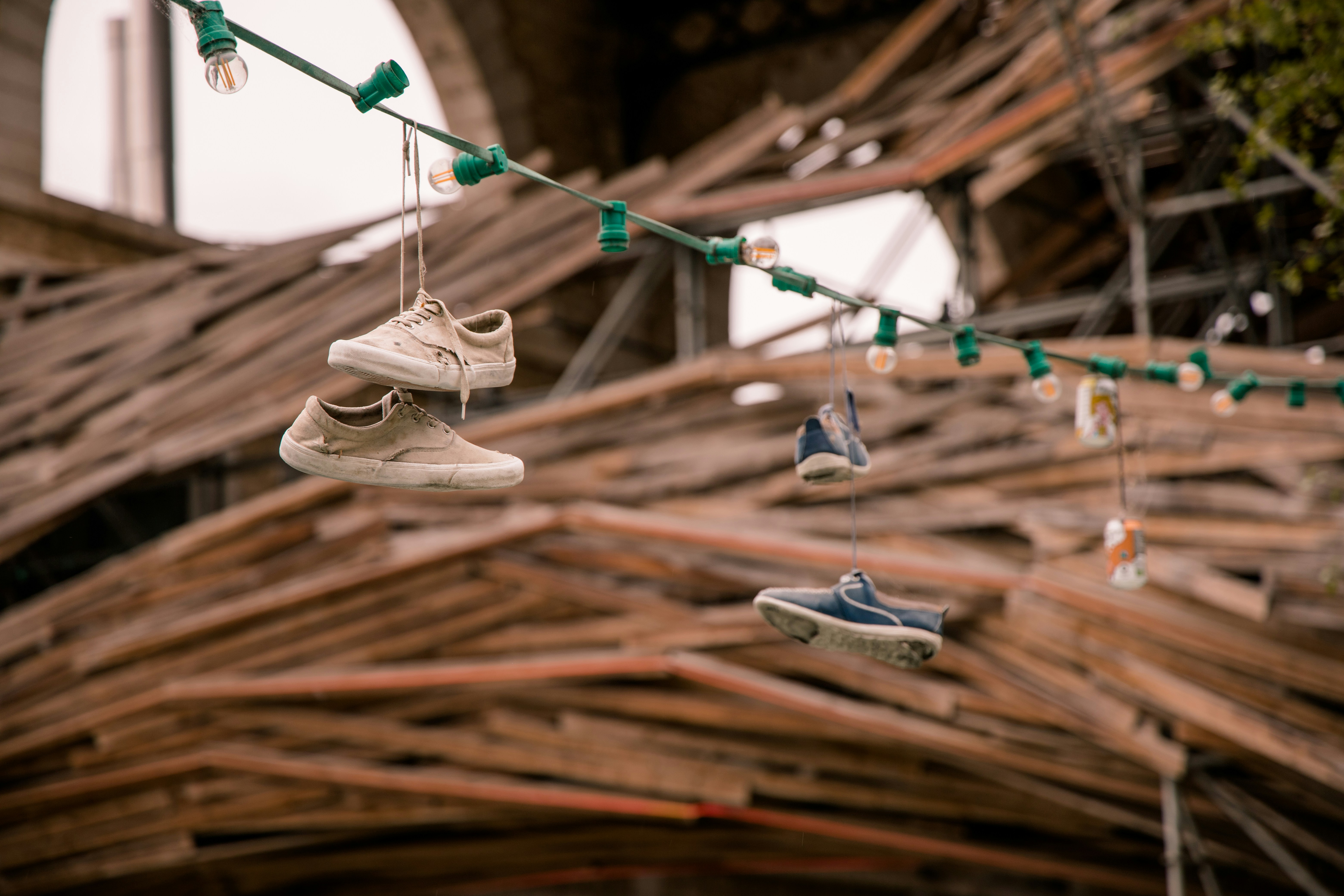 several pairs of shoes hanging from a string