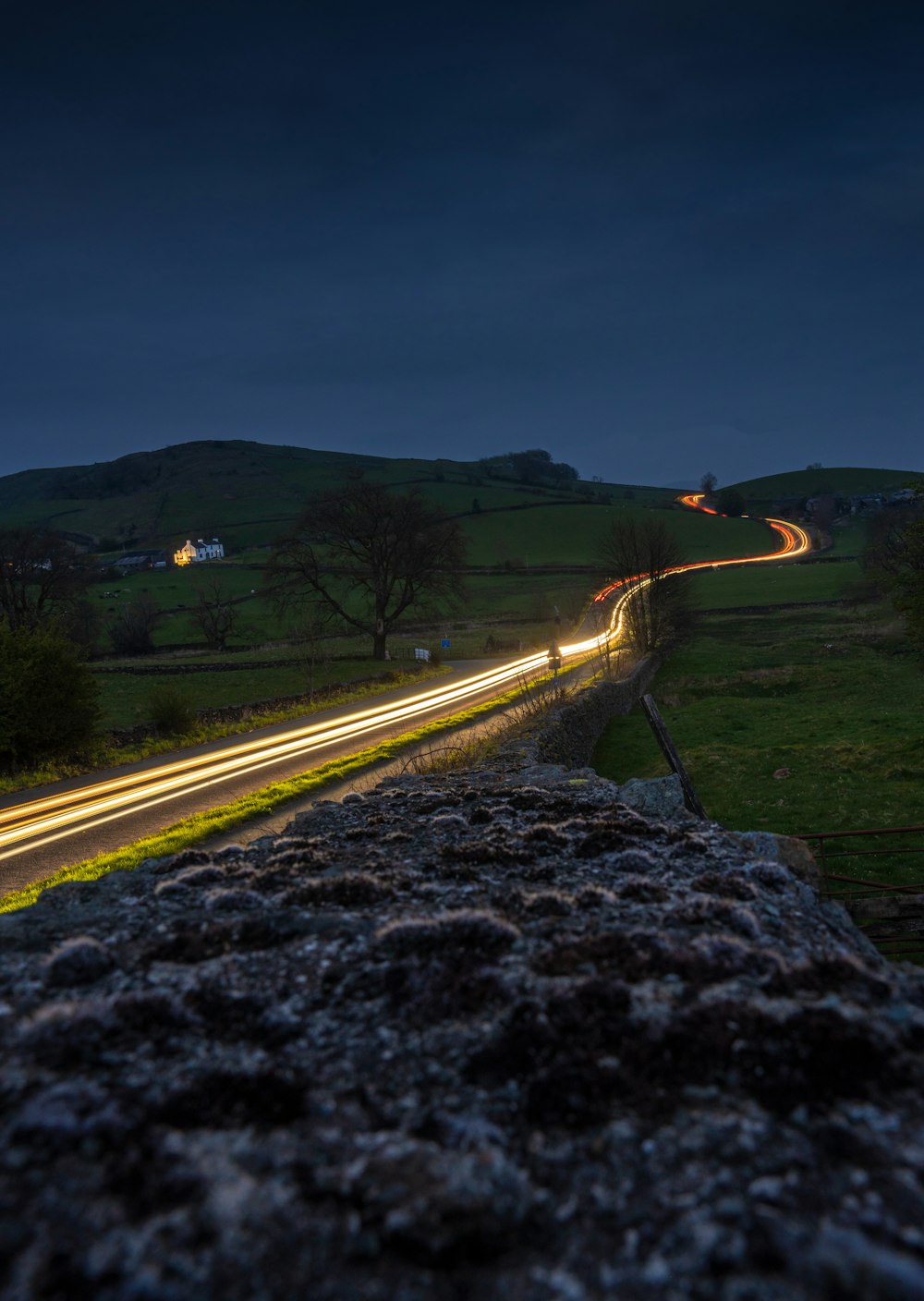 a long exposure shot of a road at night