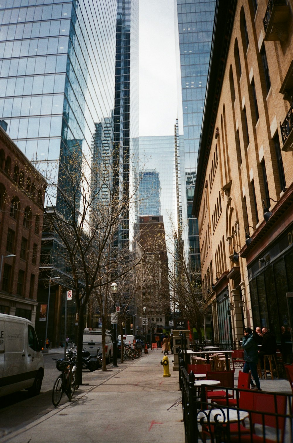 a city street lined with tall buildings and parked cars