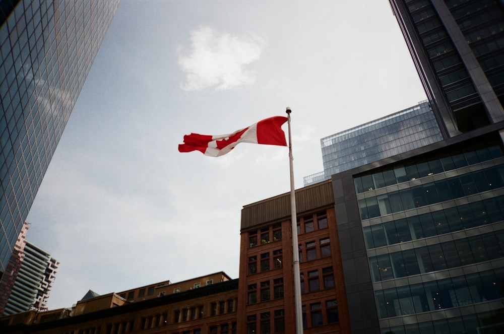 a canadian flag flying in front of some buildings
