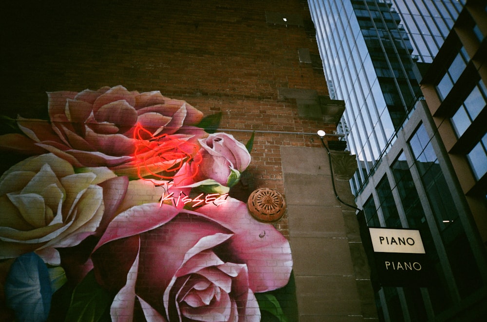 a painting of flowers on the side of a building