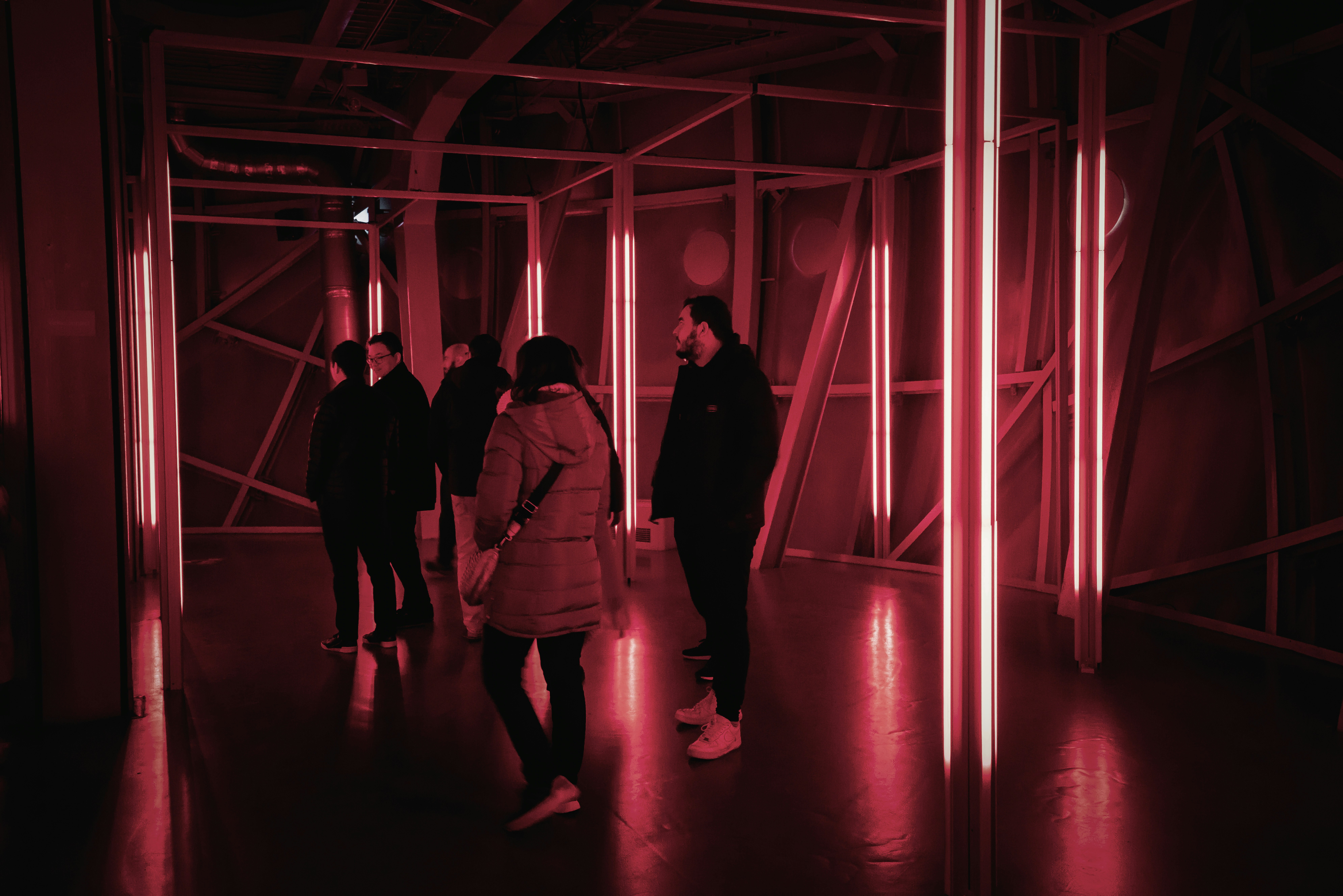 a group of people standing in a dark room
