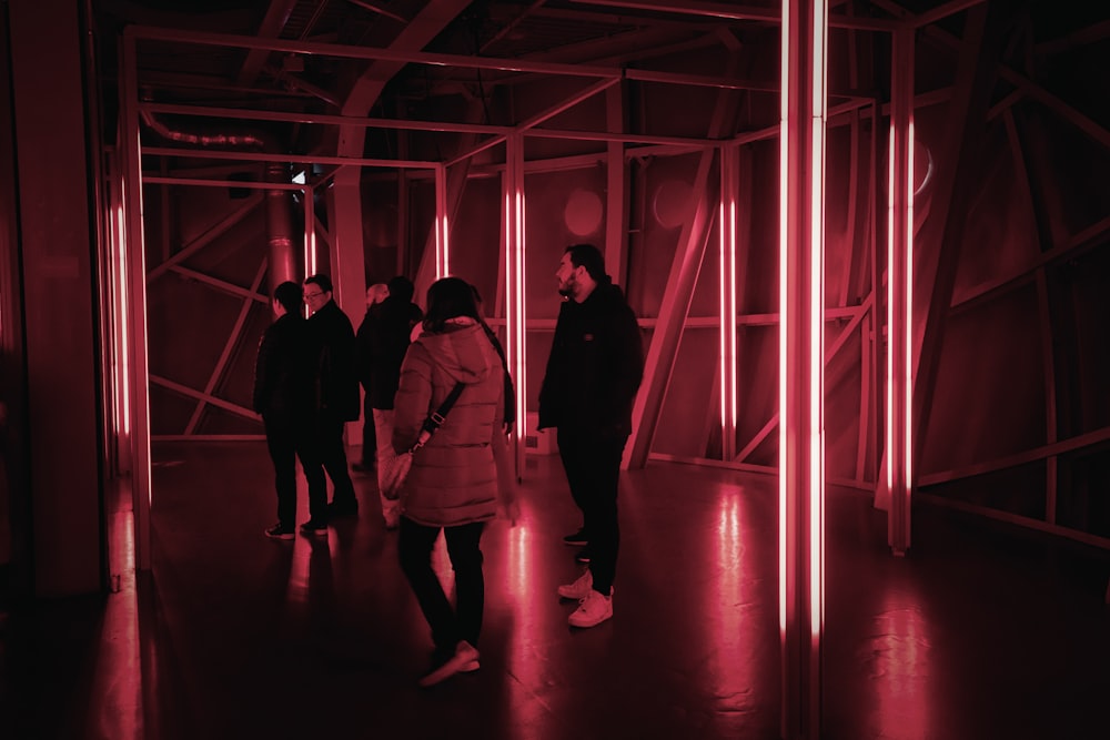 a group of people standing in a dark room