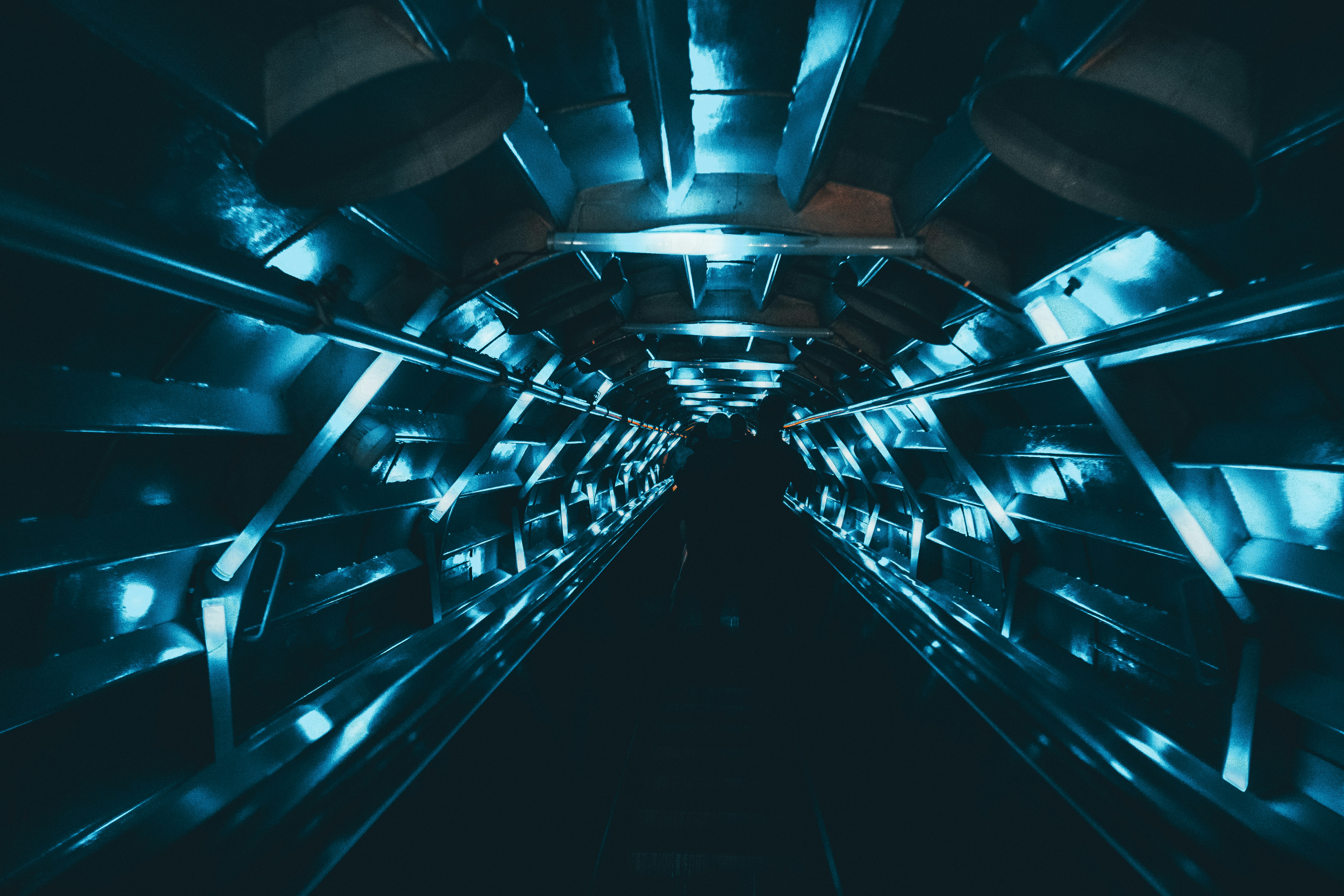 a very long and dark tunnel with some lights on