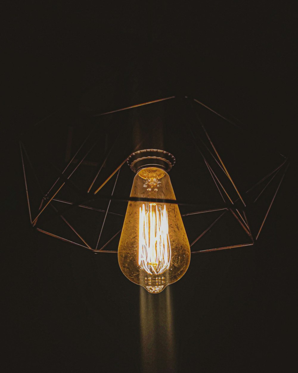 a light bulb hanging from the ceiling in a dark room