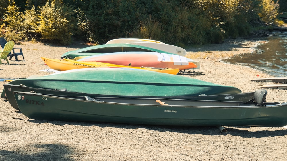 a group of canoes sitting on top of a sandy beach